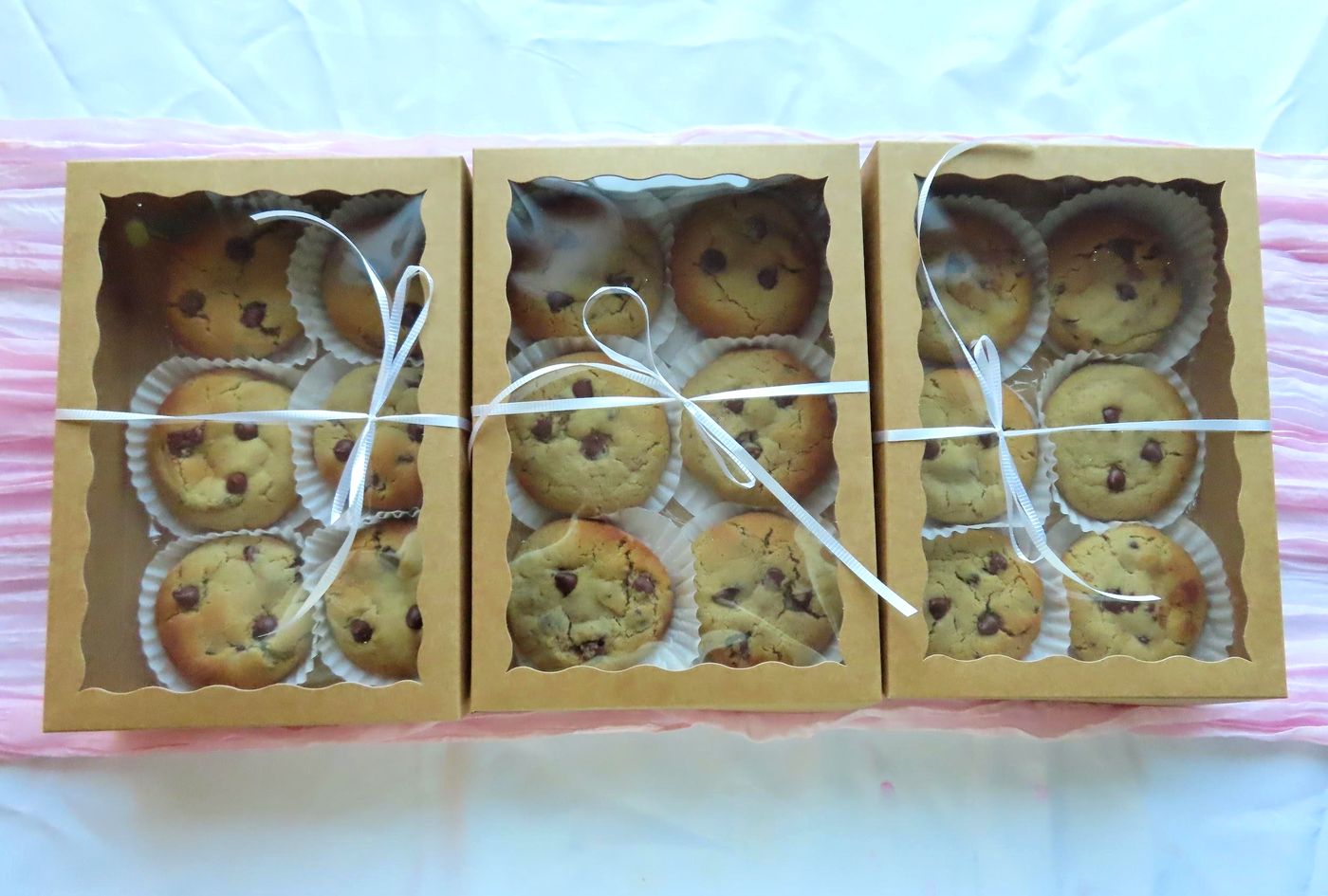 boxes of fresh chocolate chip protein cookies tied with ribbon